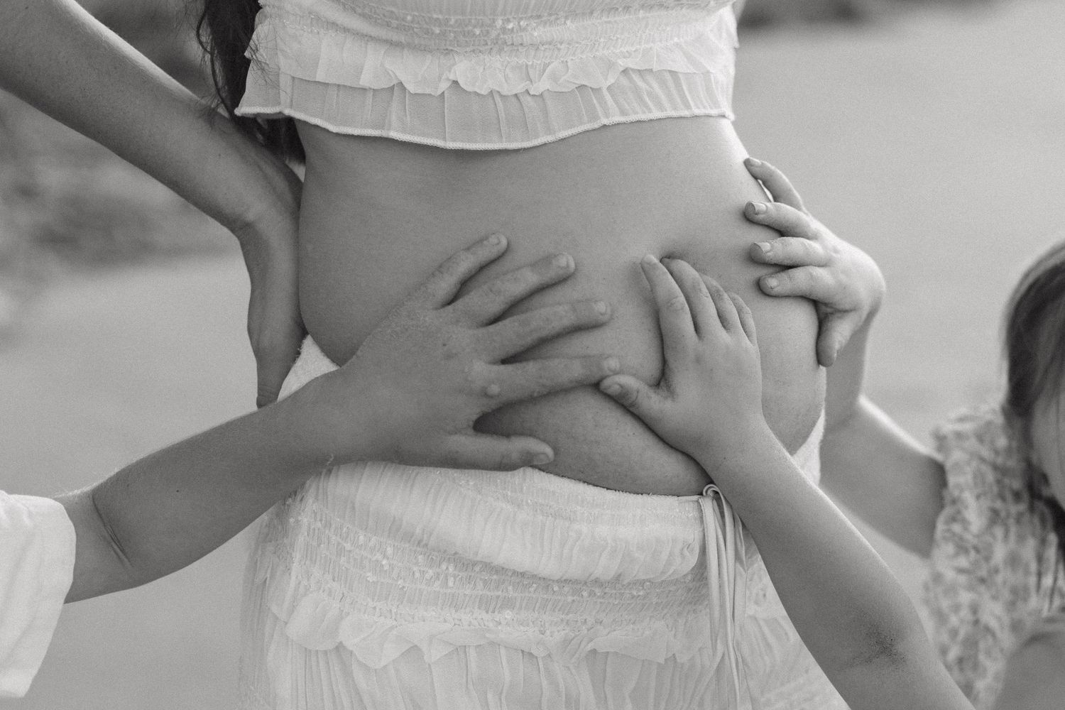 Black and white intimate photography showing gentle embraces and tender moments.