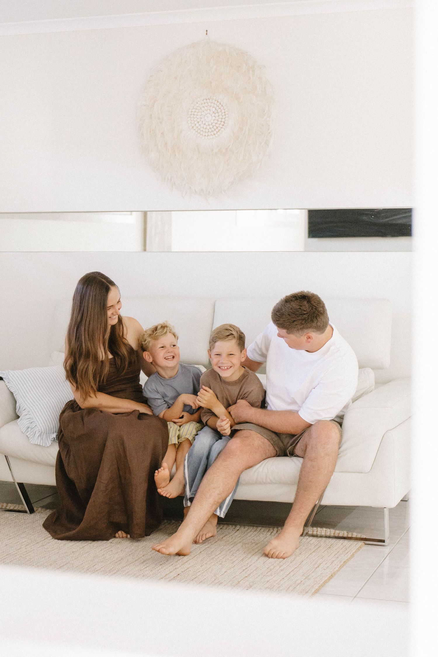 Casual family moment on white floor with their pet dog.