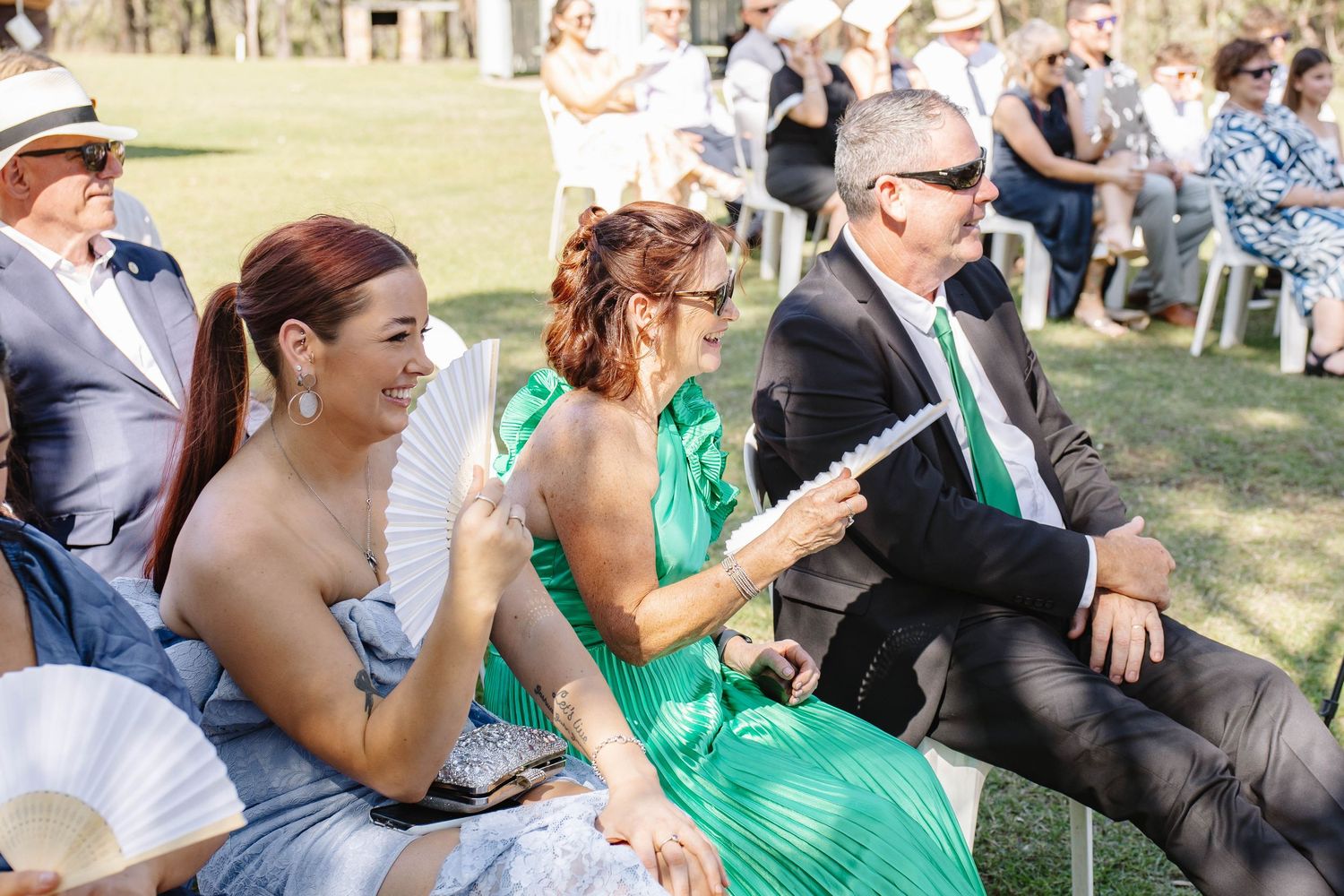 Wedding guests seated outdoors enjoying the ceremony celebrations.