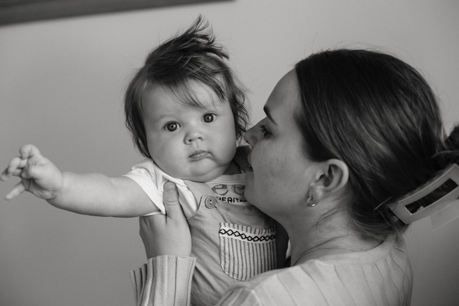 Black and white intimate portraits showing tender moments between parent and child.