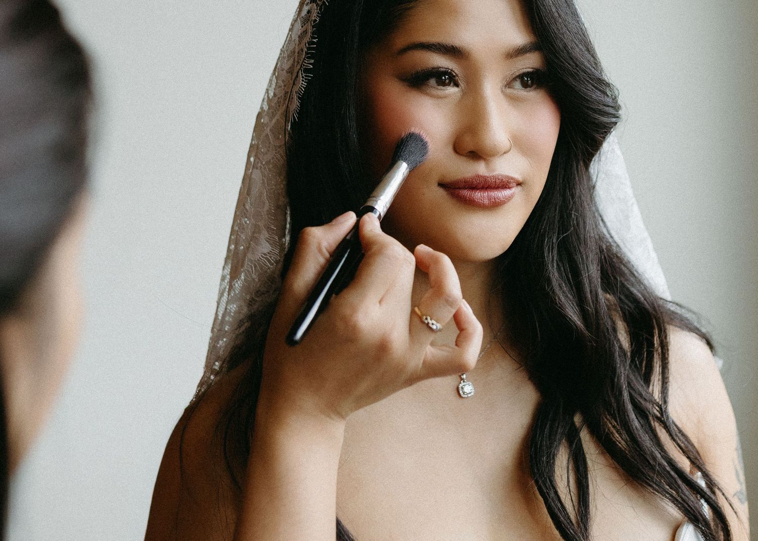 Close-up shots of bridal makeup application in natural light.