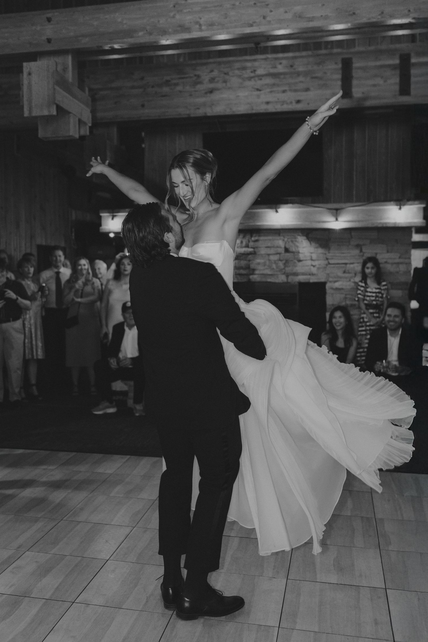 Black and white photos of wedding dance with dramatic spins and dips.