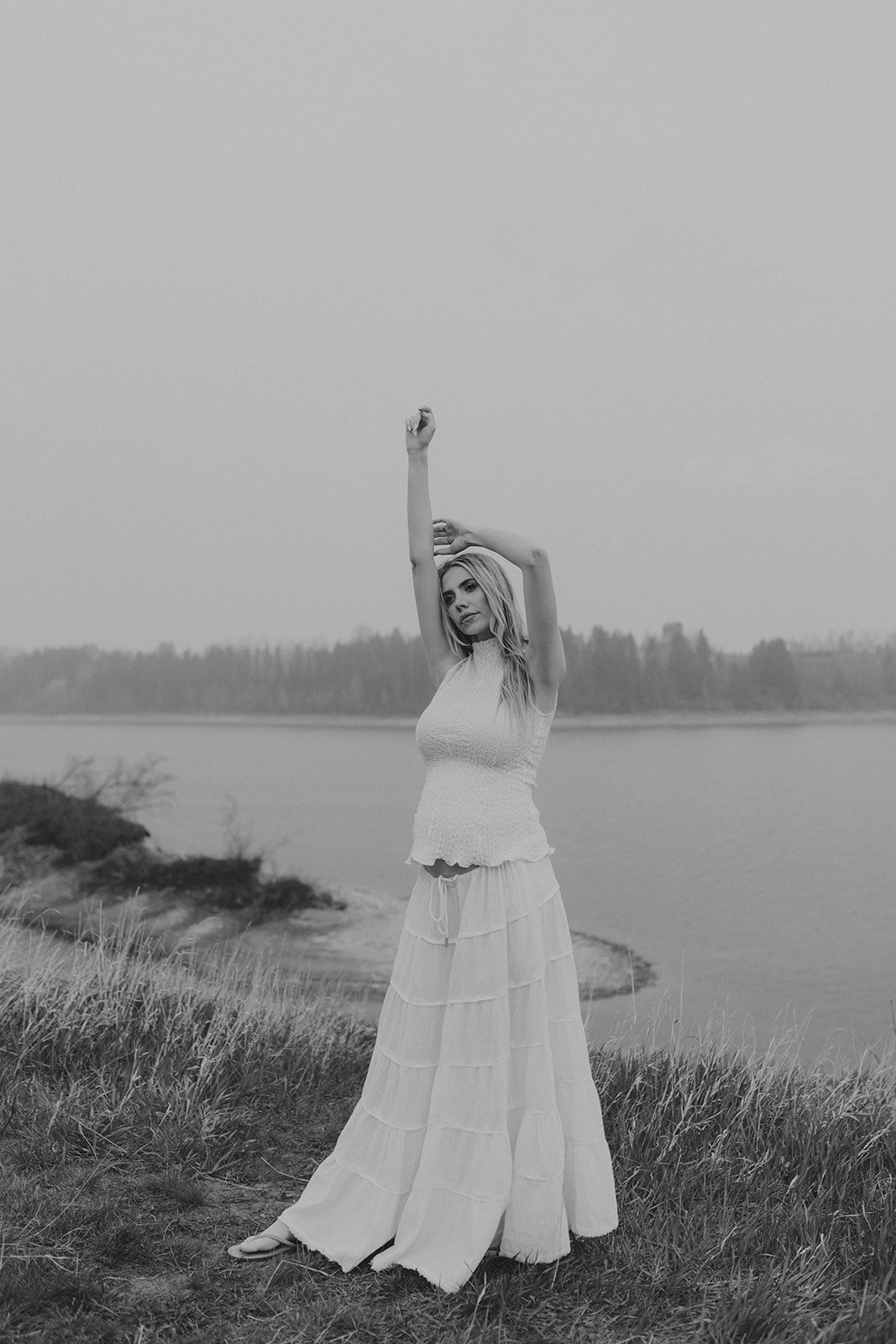 Ethereal black and white photos of a flowing white dress against a coastal landscape.