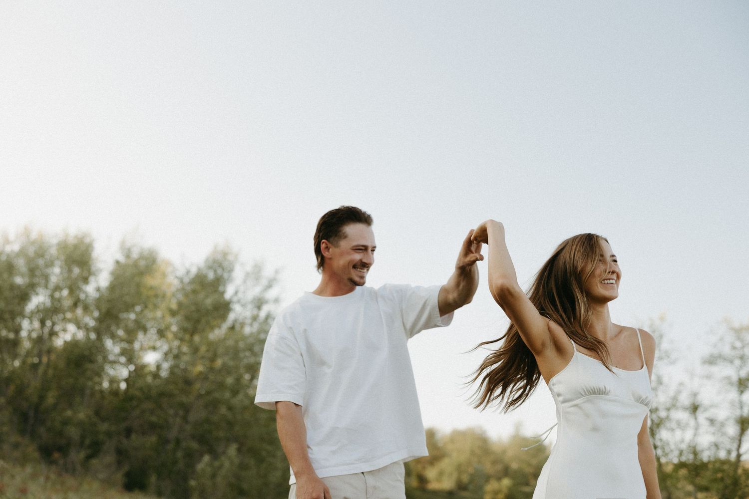 Casual couple enjoying a playful moment outdoors in natural lighting.