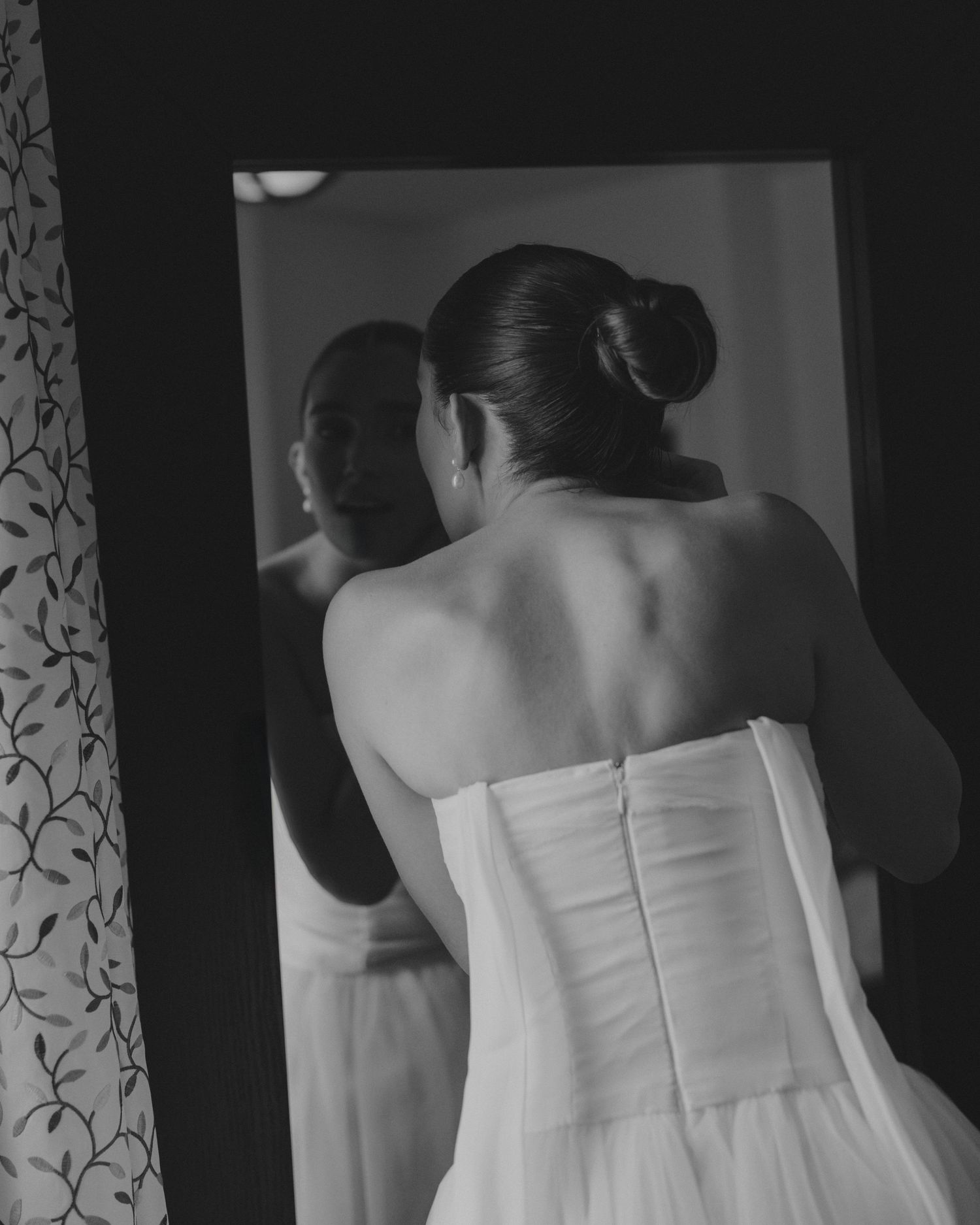 Elegant white strapless wedding dresses hanging in a row.