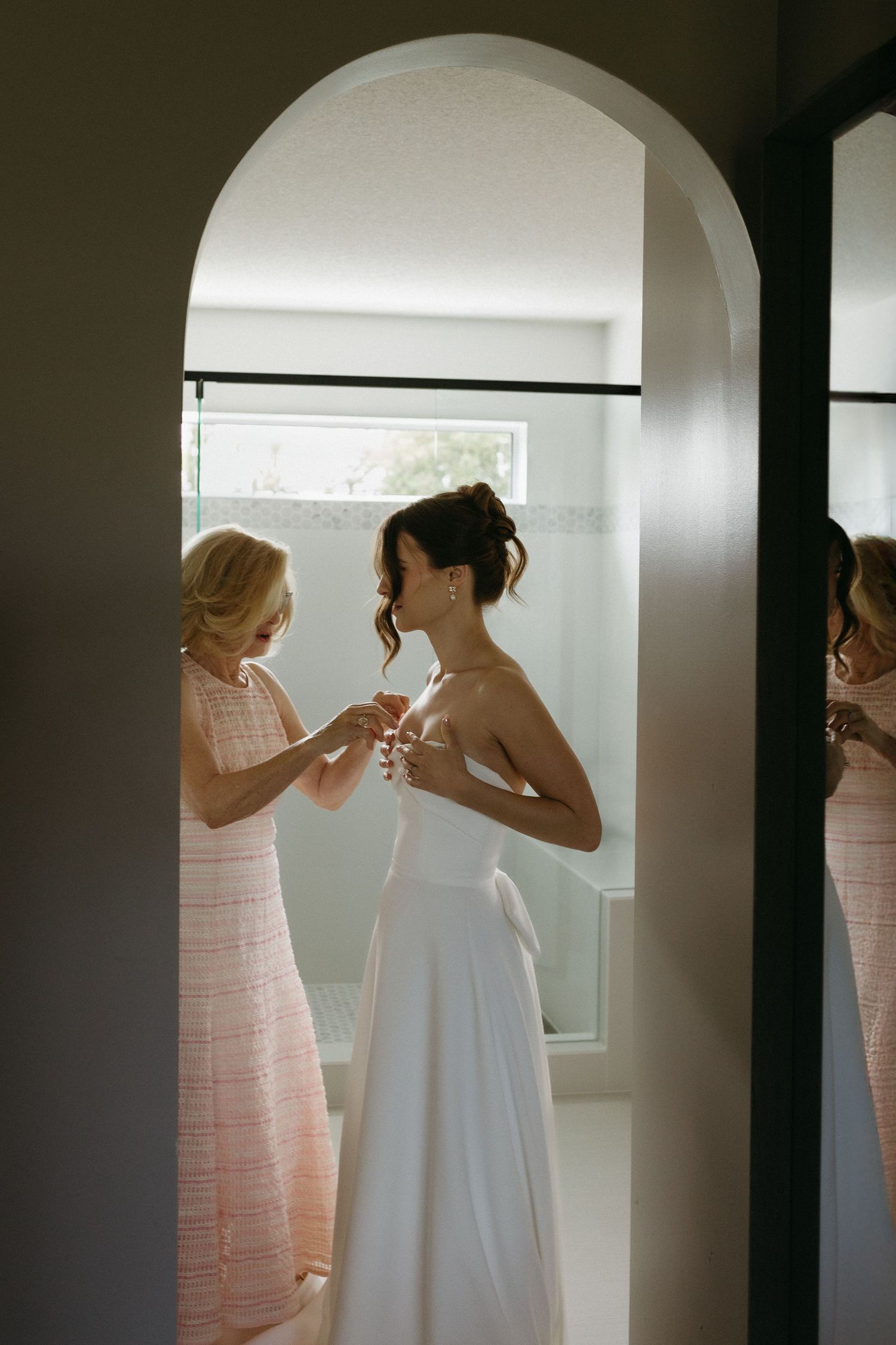 Getting ready scene with wedding preparations in a sunlit room.