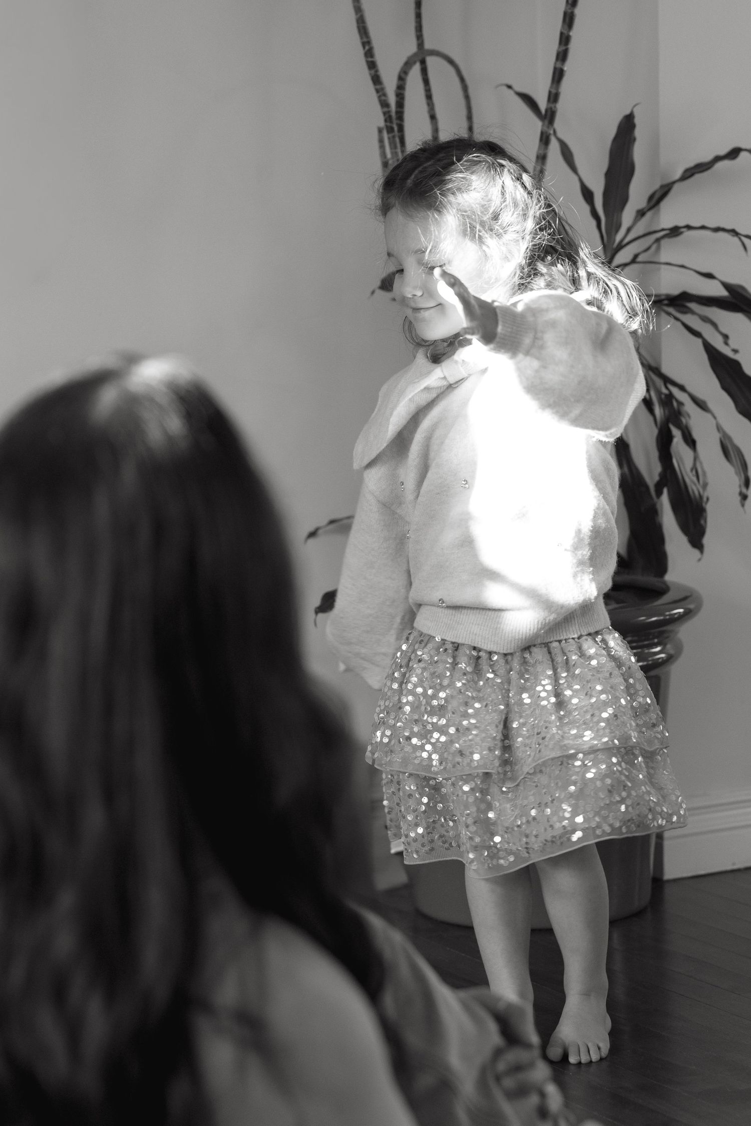 A series of black and white photos showing movement and sparkly clothing.