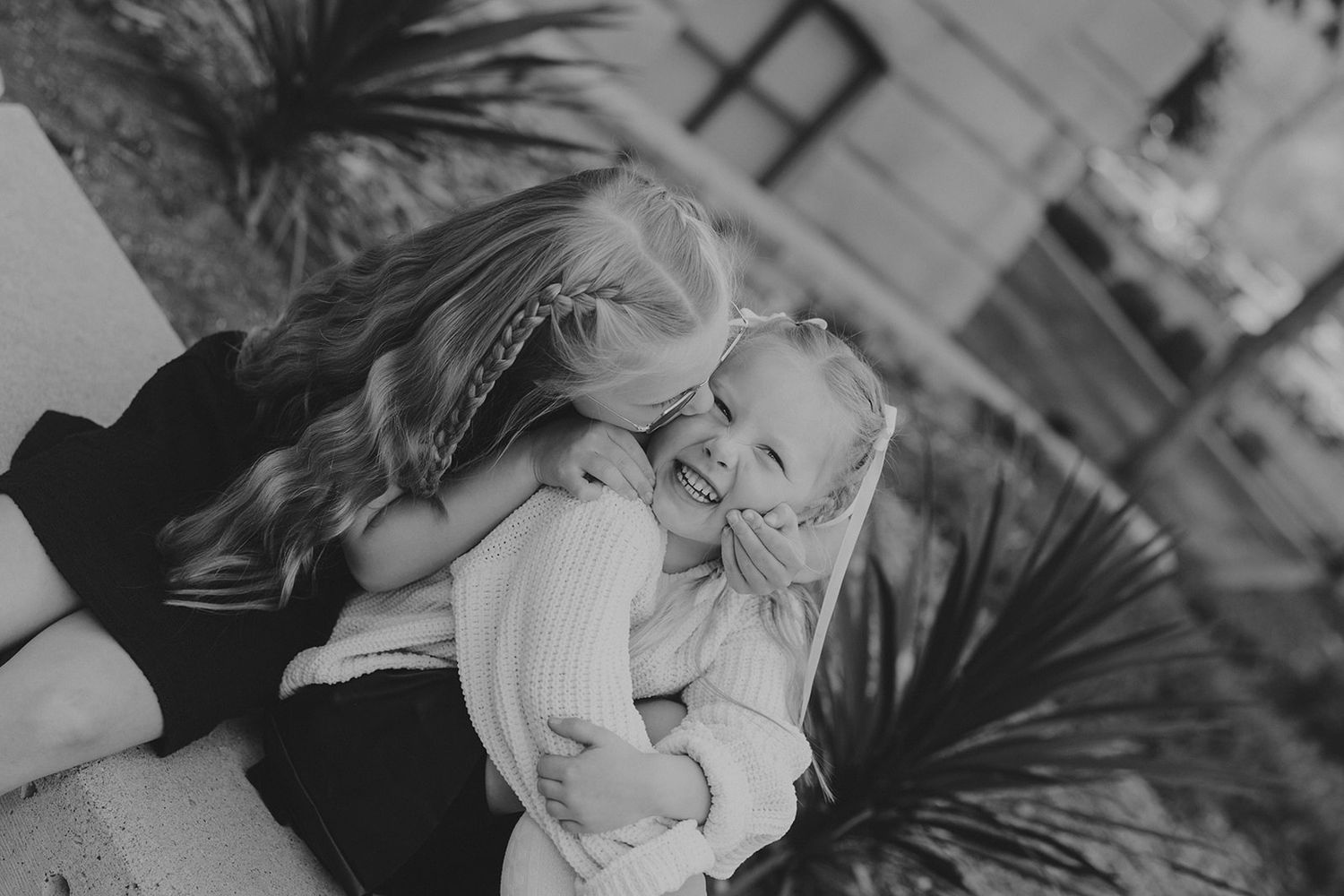 Black and white photo of children playing and laughing together.