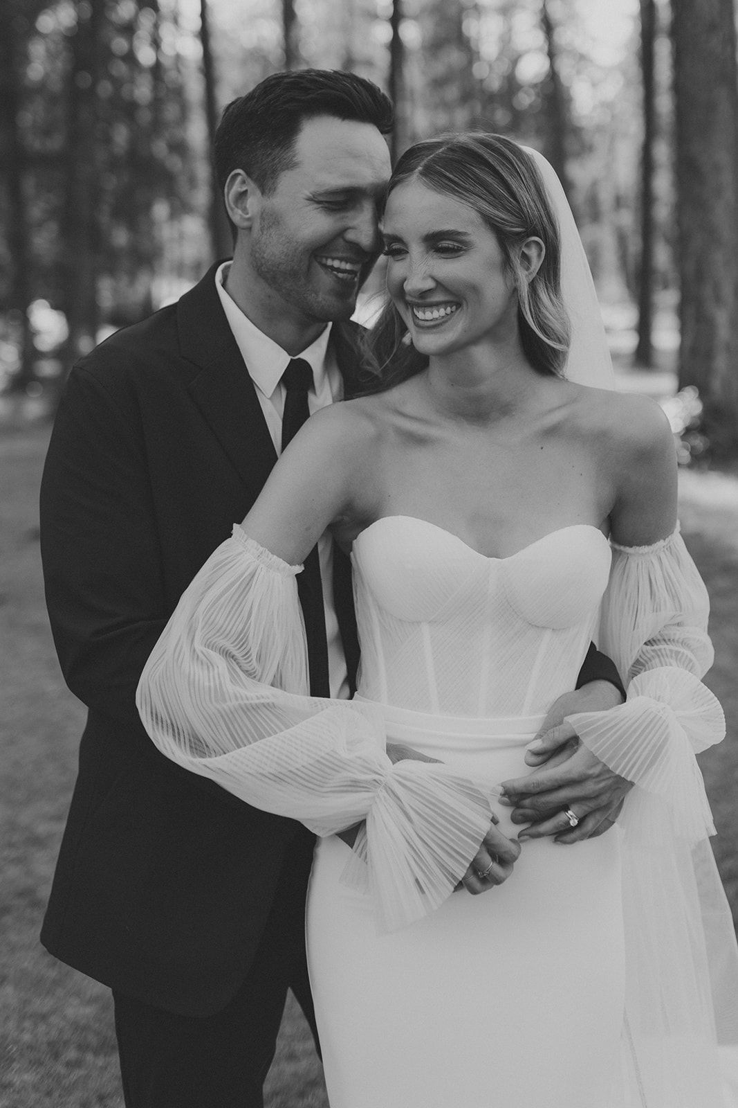 Intimate black and white wedding portraits in forest setting.