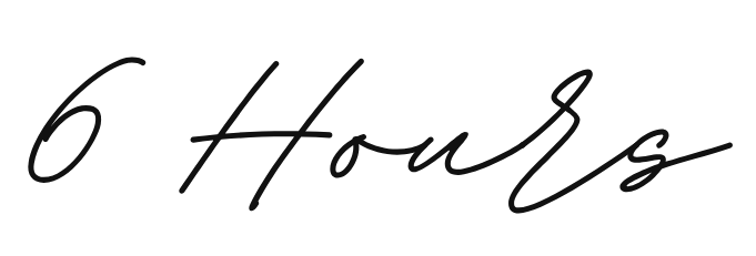 A handwritten signature in black ink appears on a white paper surface.
