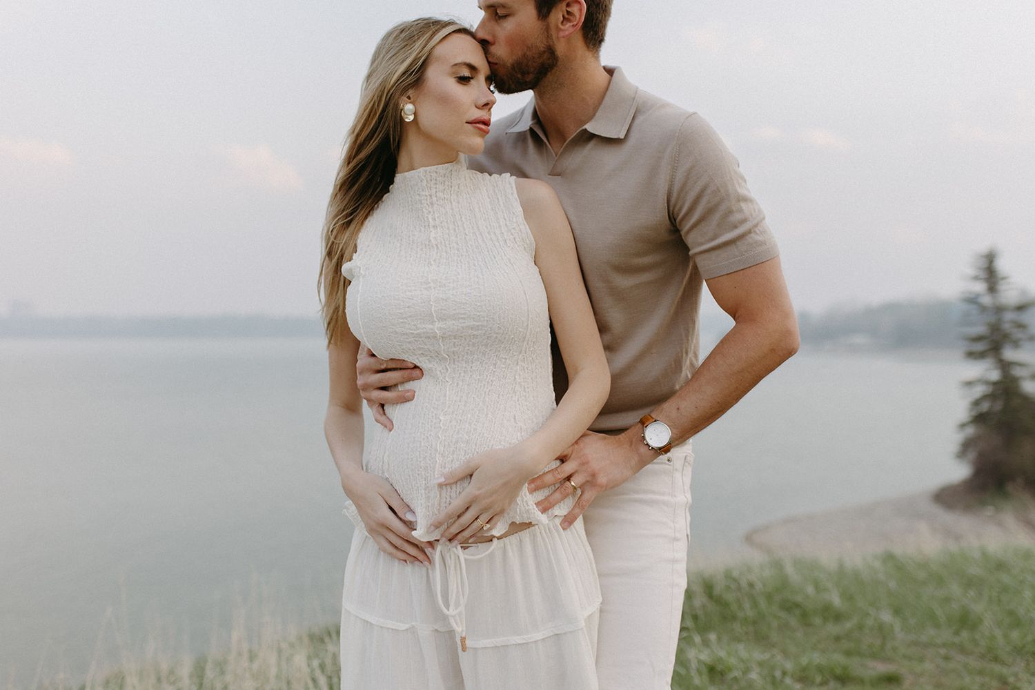Romantic couple embracing on a scenic overlook.