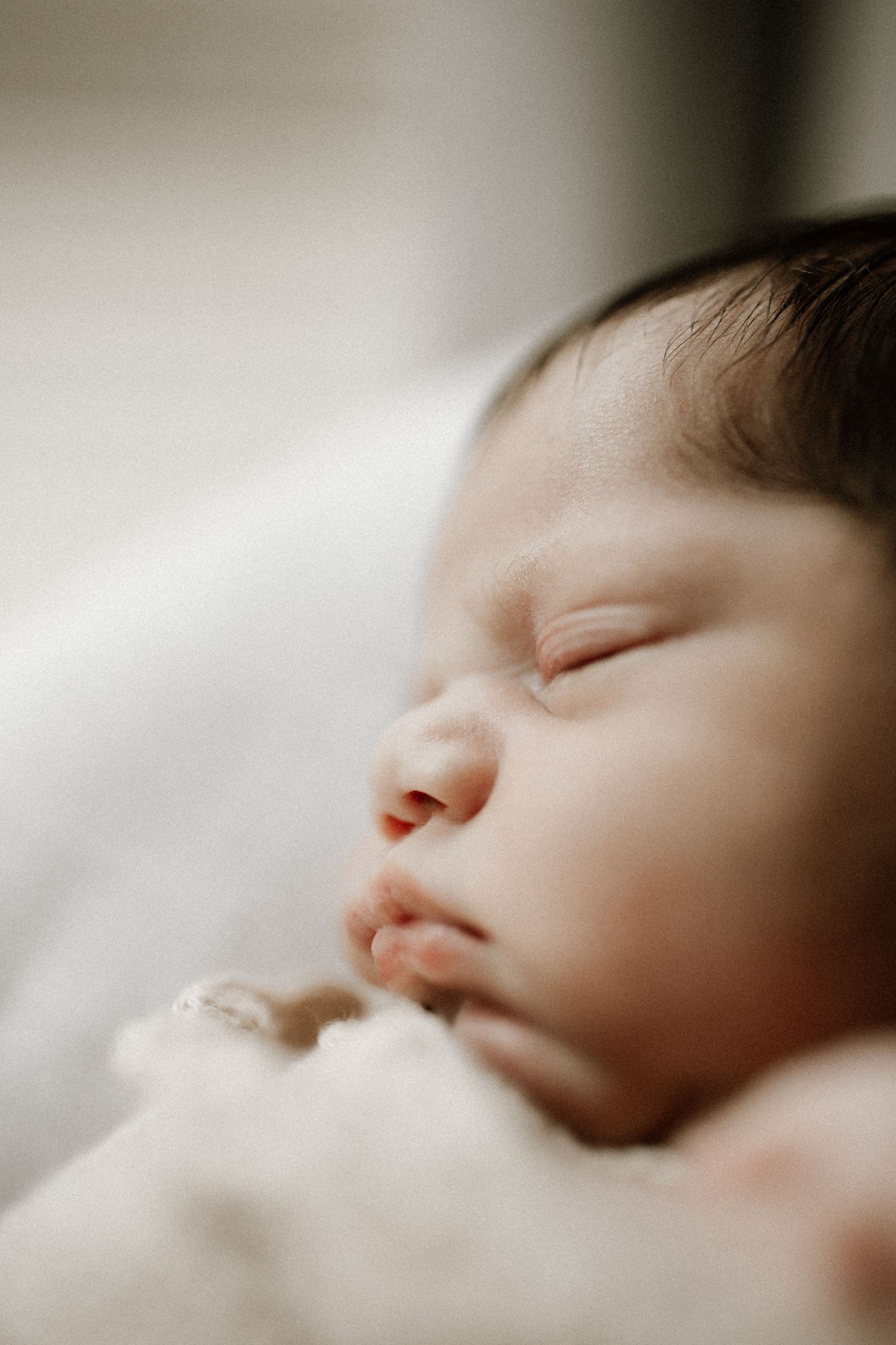 Natural newborn photography during an in home session in Bunbury capturing baby's tiny details and soft neutral tones.