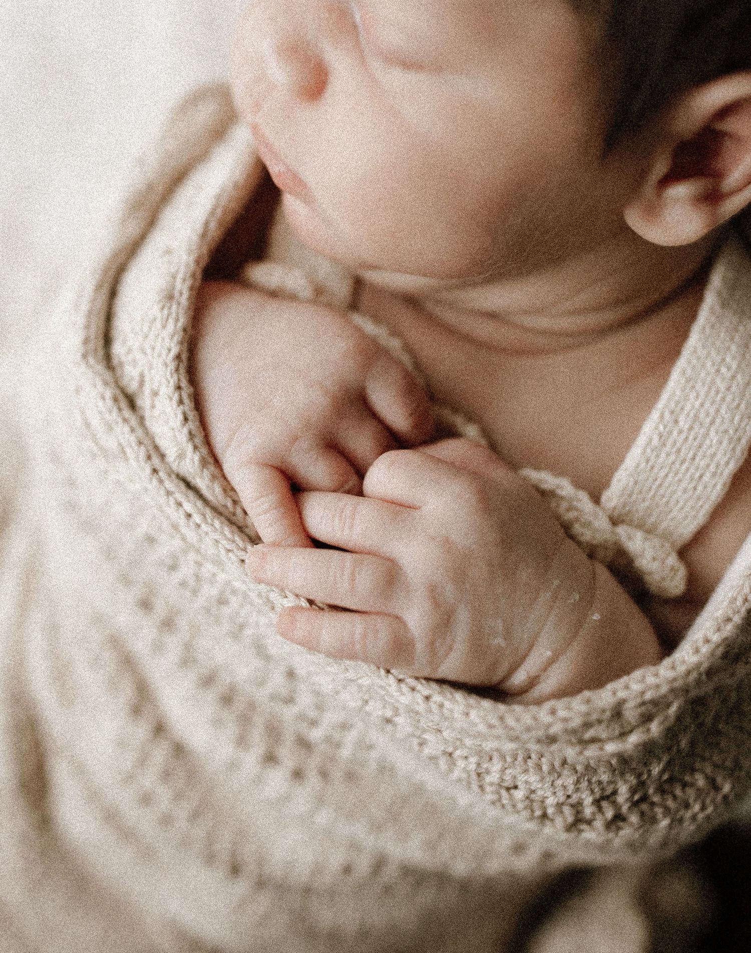 Natural newborn photography during an in home session in Bunbury capturing baby's tiny details and soft neutral tones.