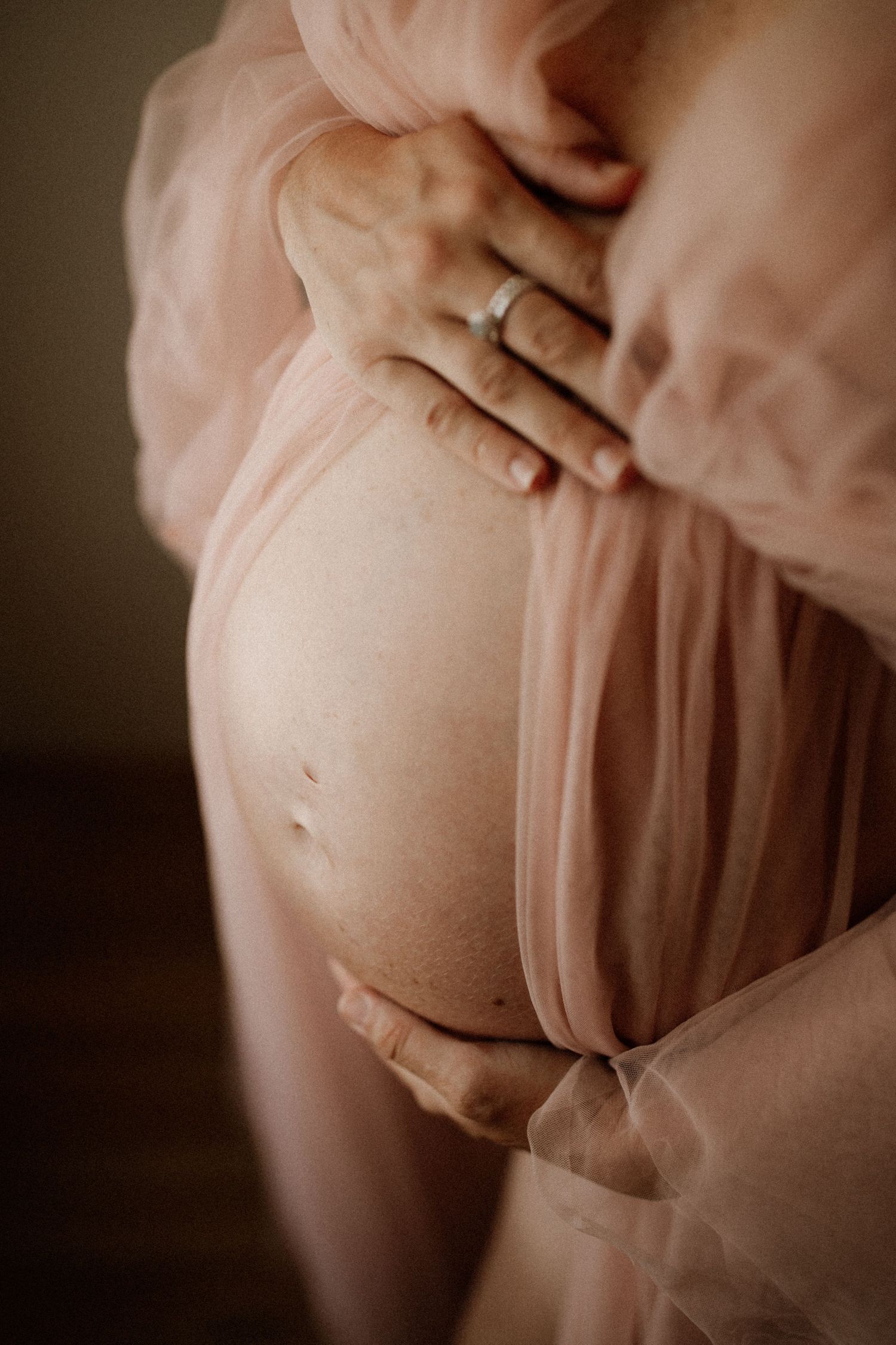 Pregnant mother wearing a flowing dress during an in home maternity session in Bunbury, Western Australia.