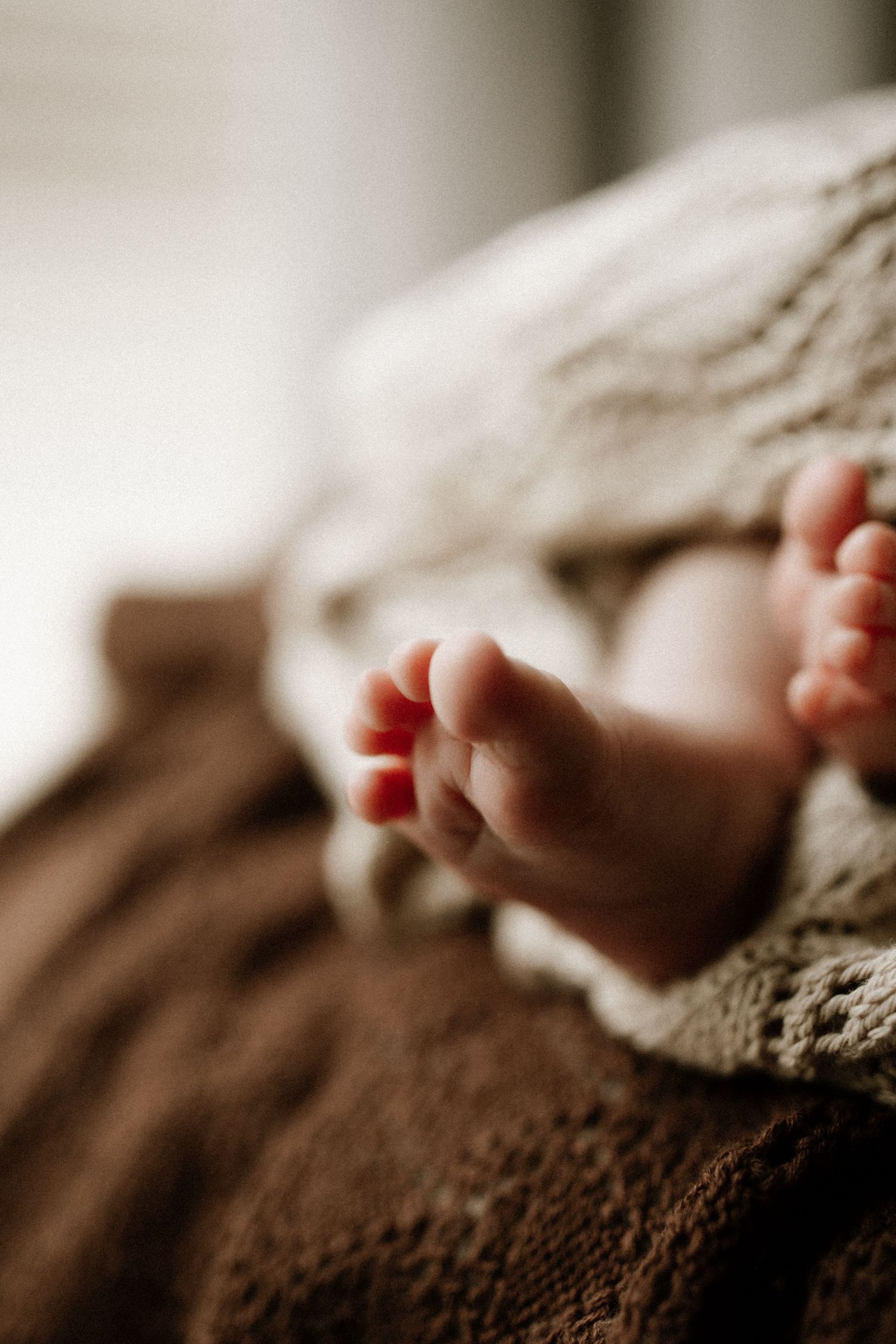 Natural newborn photography during an in home session in Bunbury capturing baby's tiny details and soft neutral tones.