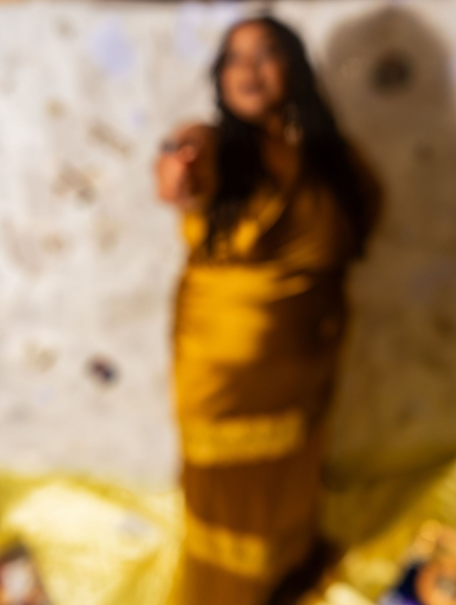 Blurred photo of a Beautiful Black woman with locs in a beautiful Goldem Brown dress