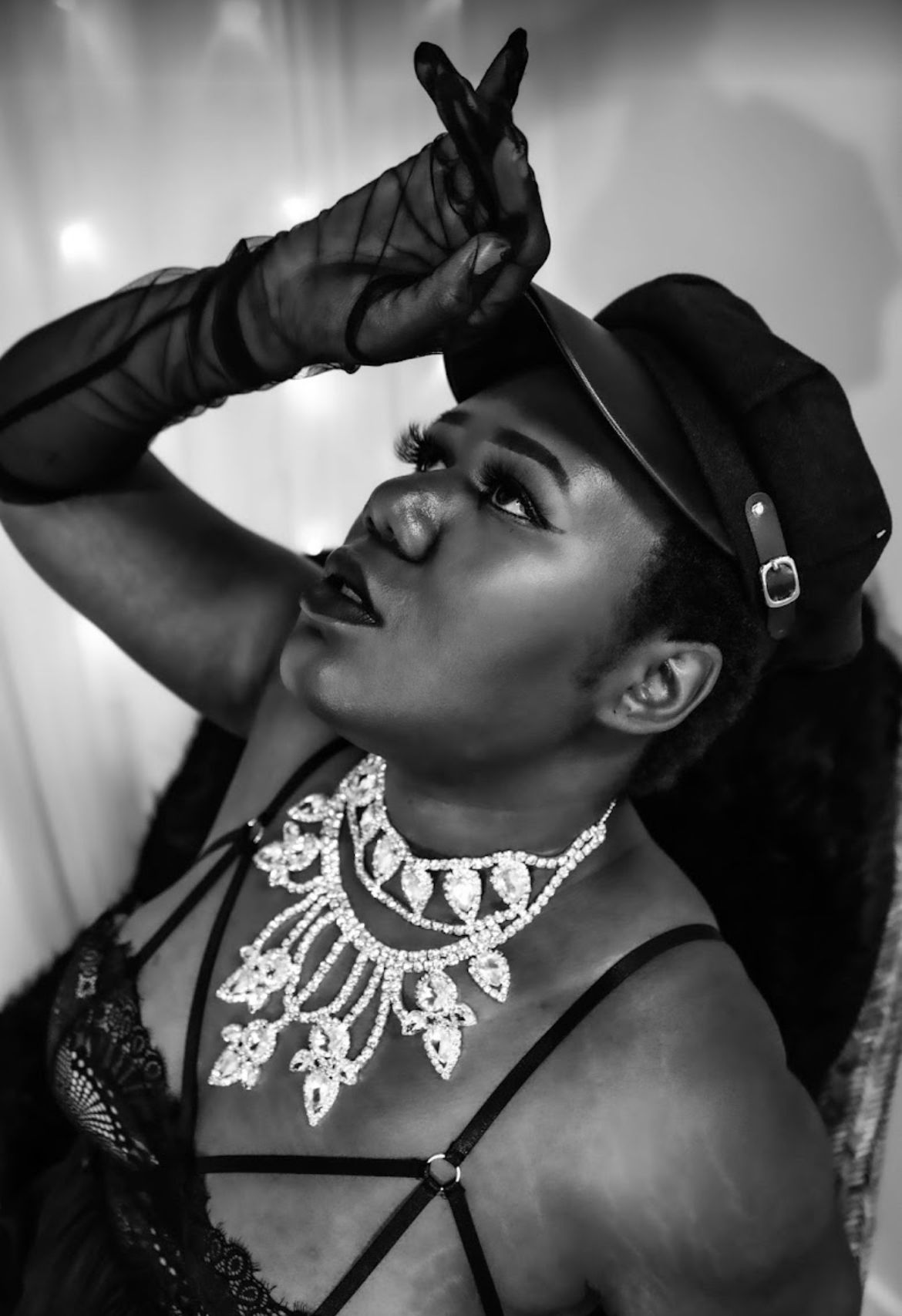 Black and white image of plus size Black woman in a burlesque inspired photo session. super short hair. Boudoir by Hinton Imagery in ENC