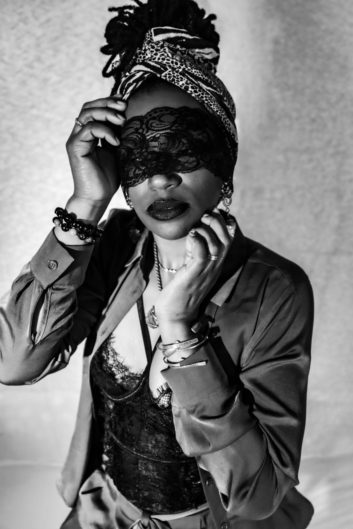 Boudoir portrait session by Hinton Imagery Jacksonville NC. Lace over eyes. Hands framing face. Black woman with locks Black & white image