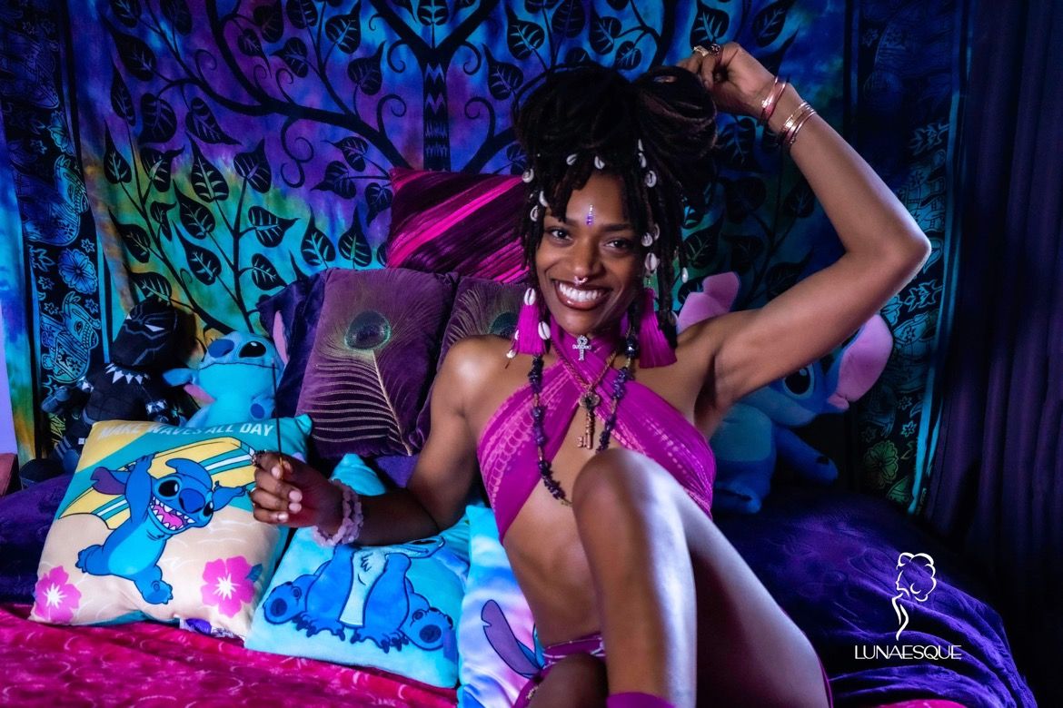 deep colors and beautiful Black woman with locs sitting on her bed with Incense and relaxing. Hinton Imagery empowering experience