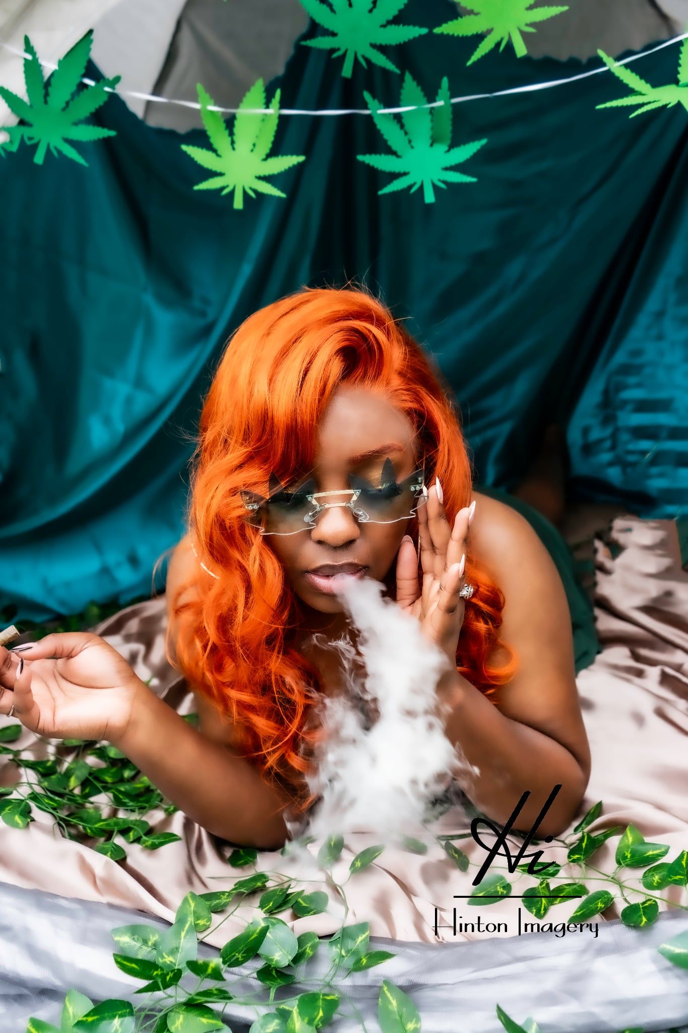 Boudoir portrait session 420 inspired, a Black woman blowing out smoke with a gorgeous Orange curled wig. Jacksonville NC Hinton Imagery