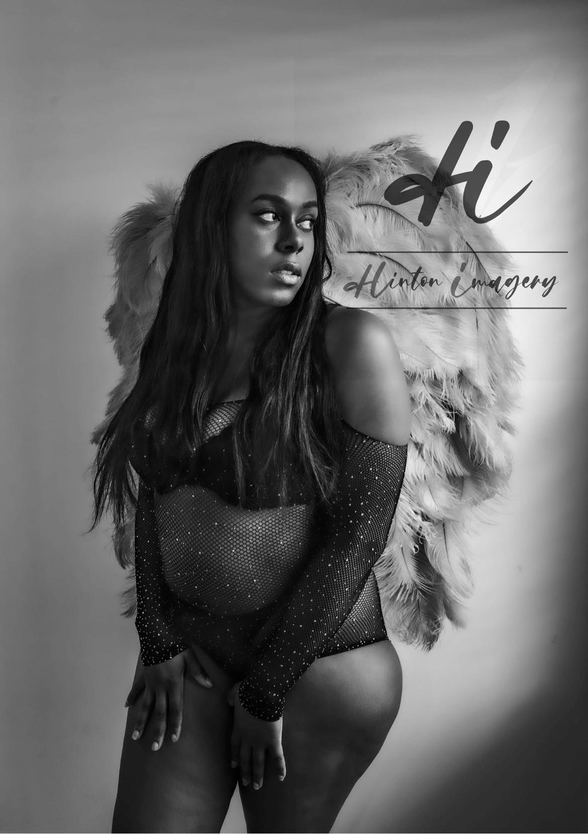 Black & white photo of Boudoir portrait session in Jacksonville NC. Black woman in a sparkly body suit