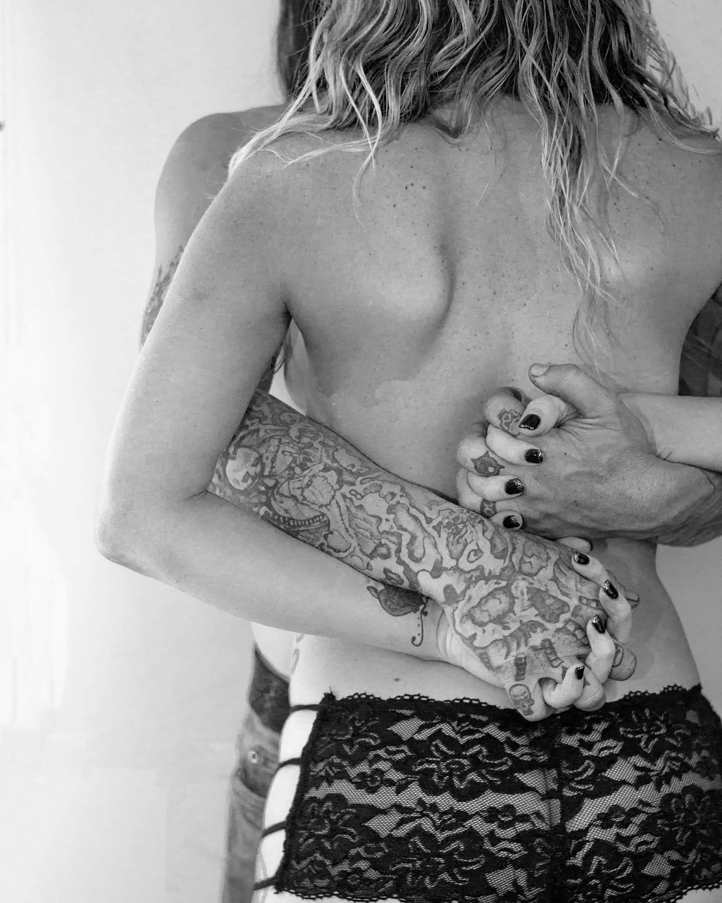 BLack and white image of a couple sharing an embrace in a Boudoir session by Hinton Imagery in Jacksonville NC