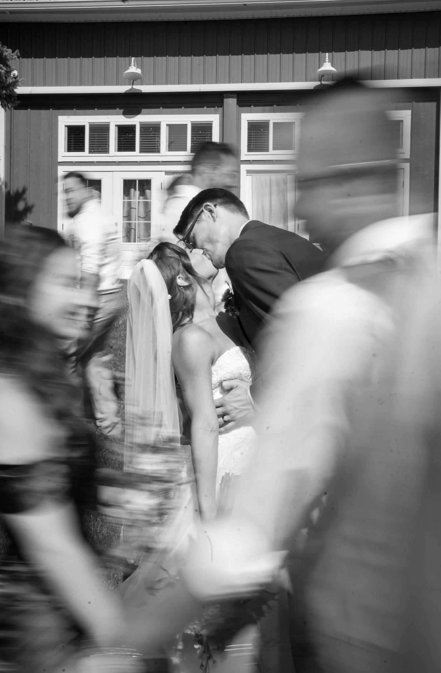 A black and white motion blur photo captures a couple's first dance at their wedding reception.