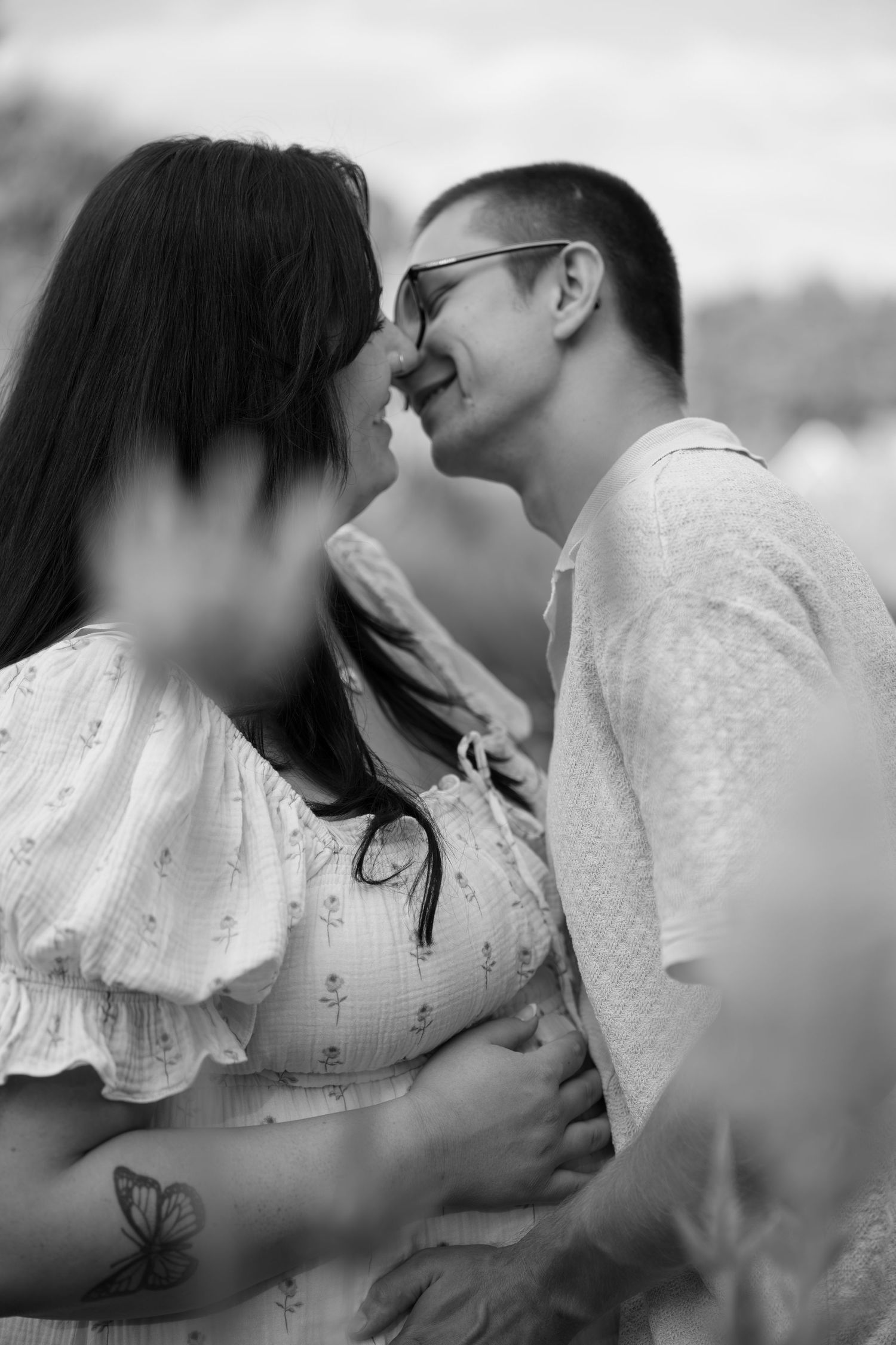 Black and white series showing intimate romantic moments between couple in white lace clothing.