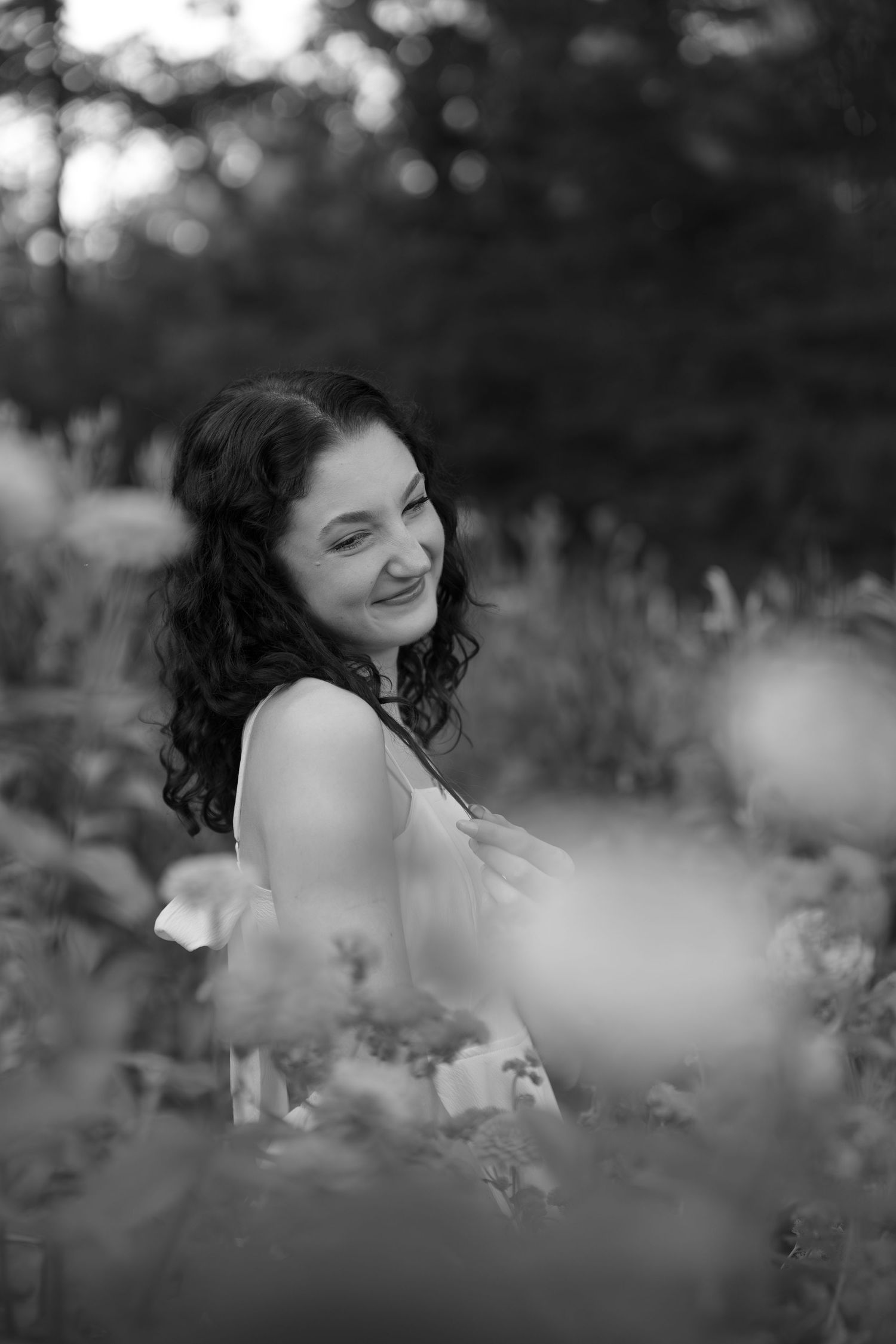 Dreamy black and white photography sequence captured among outdoor flowers and greenery.