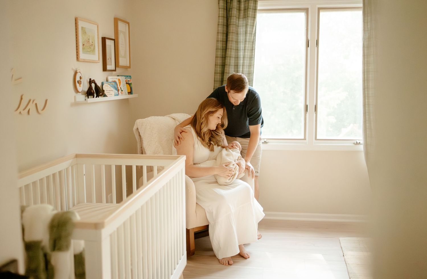 Intimate nursery scene with soft natural light streaming through windows.