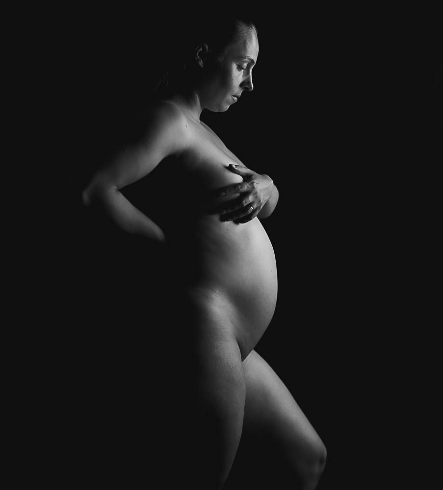 Artistic black and white maternity silhouette emphasizing the changing form during pregnancy.