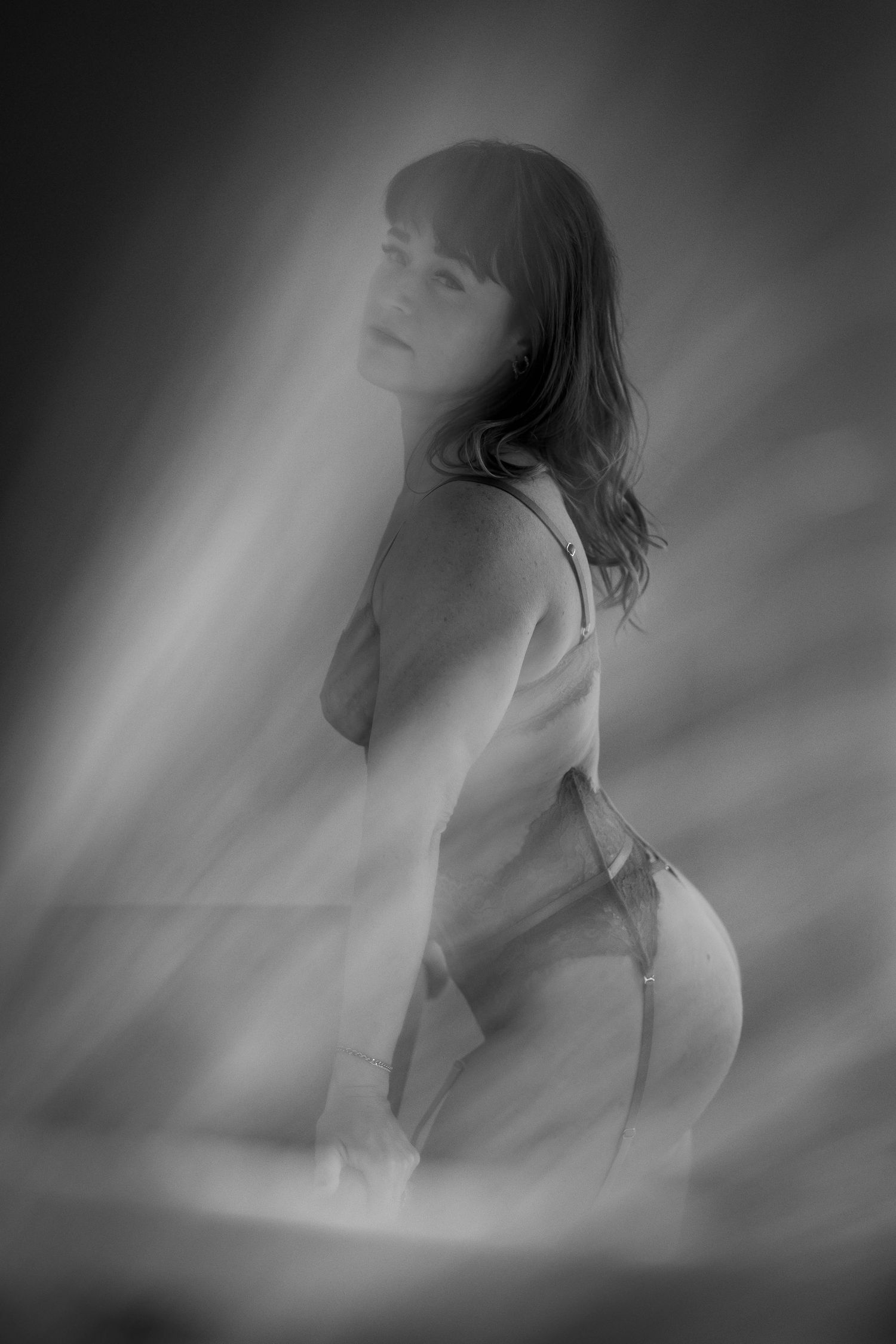 Dreamy black and white silhouette poses in soft lighting.