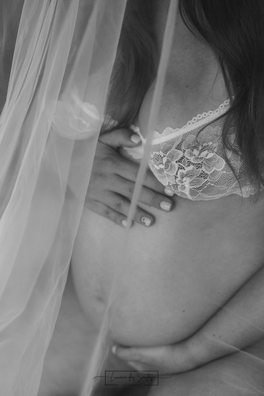 Close-up black and white photo of delicate lace details against skin.