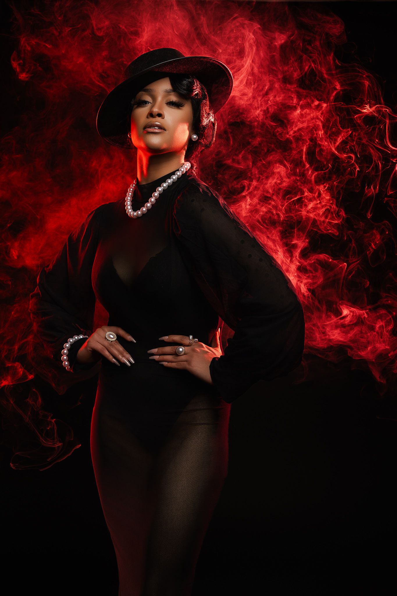 Dramatic portrait series with figure in black against swirling red smoke effect background creating moody atmosphere.