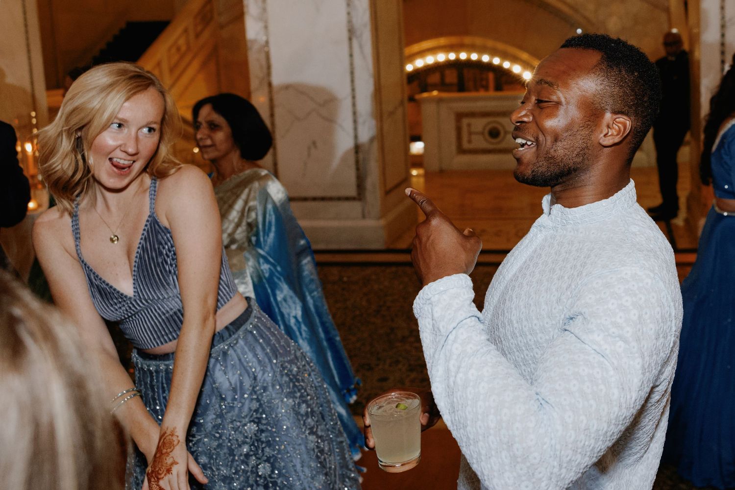 Interracial couple dancing at a South Asian Indian wedding reception at the Chicago Cultural Center
