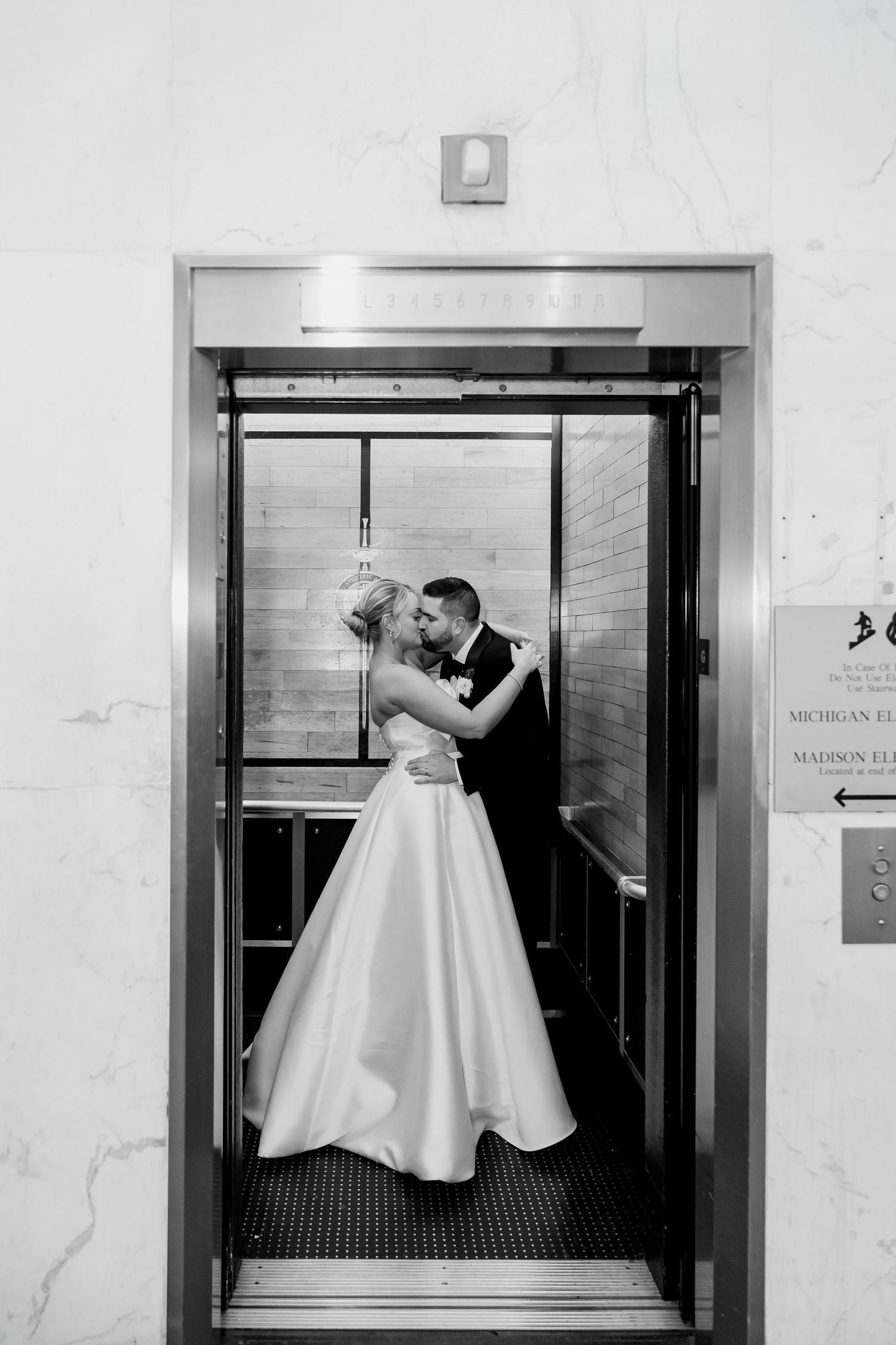 Couple kissing inside elevator at Chicago Athletic Association