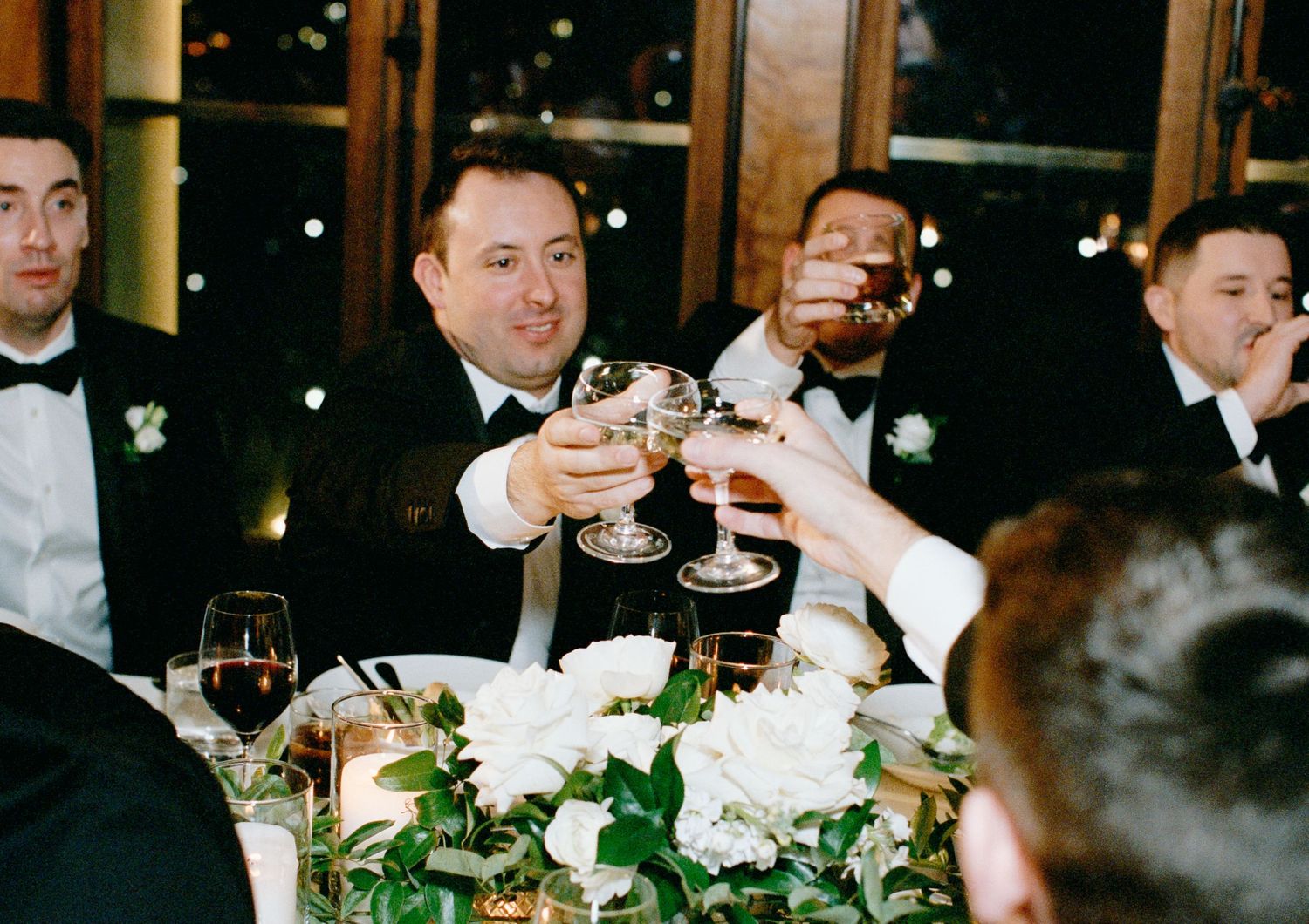 Grooms toasting during wedding reception at Chicago Athletic Association