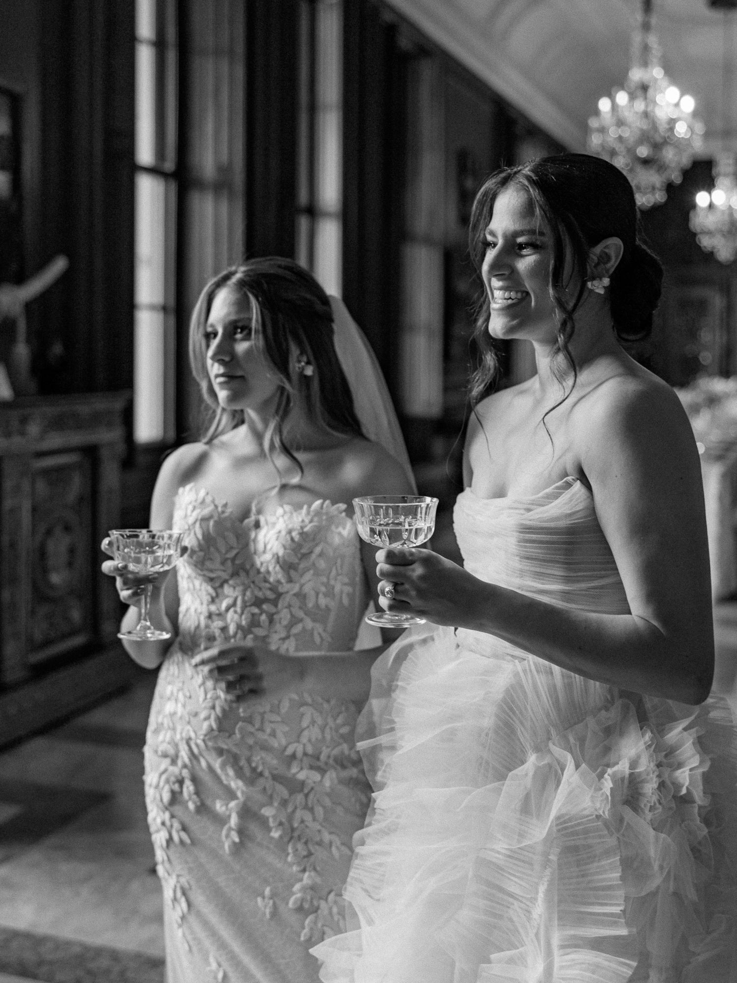 Black and white portrait of a lesbian couple listening to a special toast during their wedding reception at Larz Anderson House, Washington,