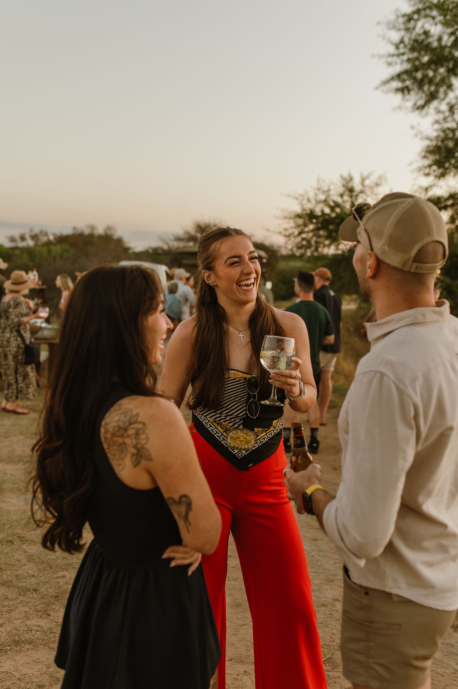 Candid shots of friends laughing and drinking at an outdoor gathering at dusk.