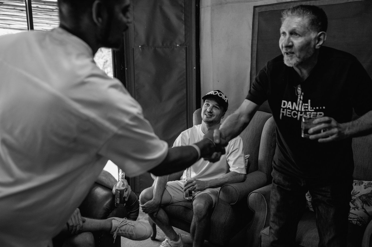 Black and white candid shots showing casual interactions in an indoor setting.