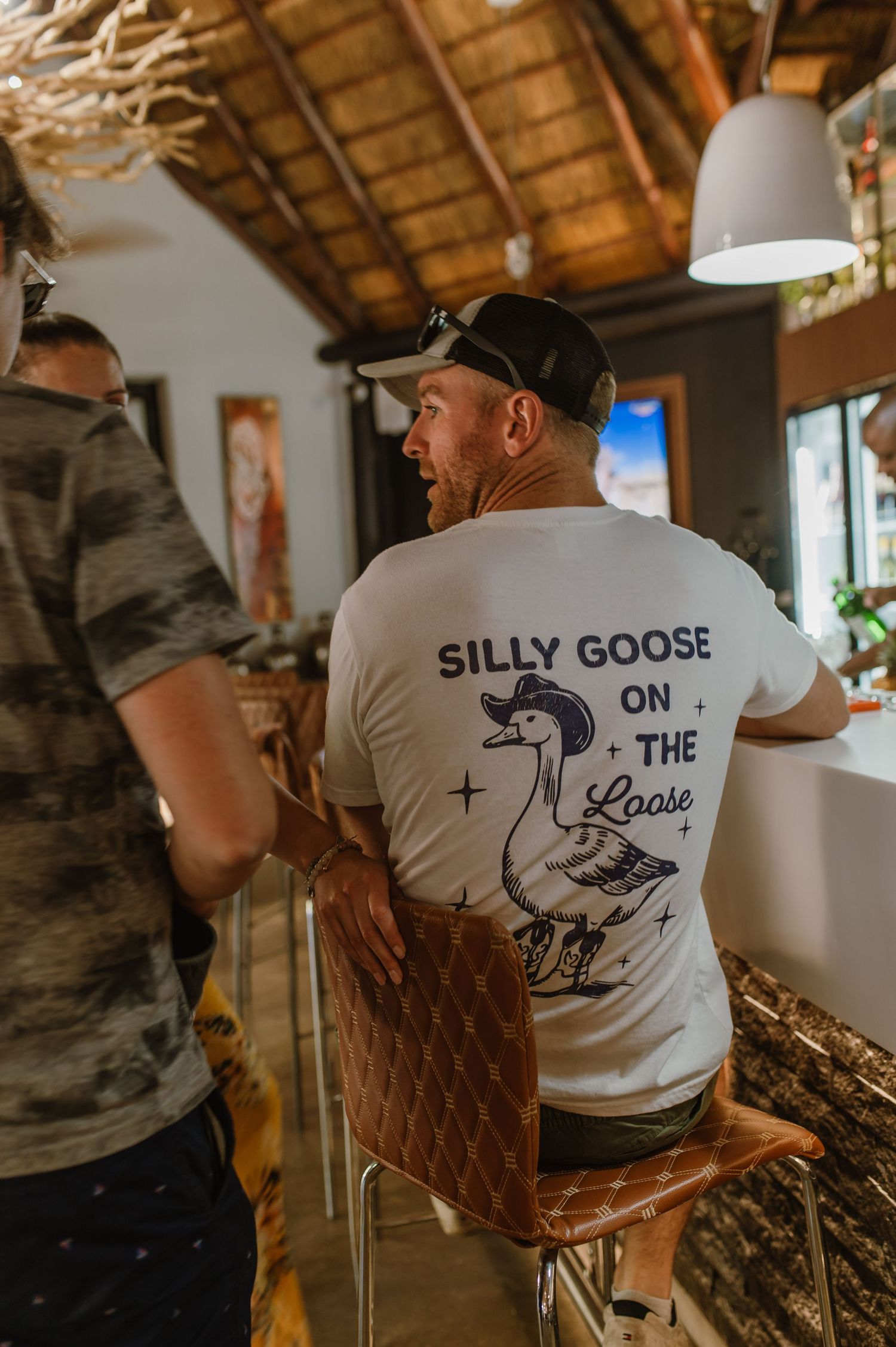 Musicians wearing Silly Goose branded t-shirts performing at indoor venue.