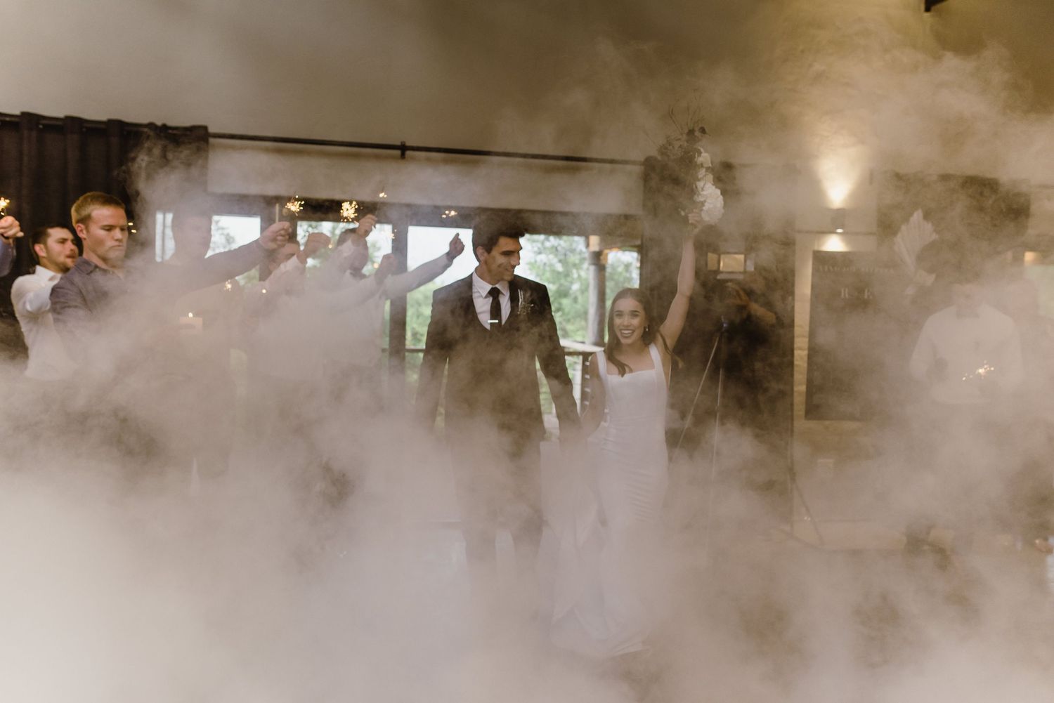Atmospheric fog effect fills a reception venue creating a dreamy ambiance.