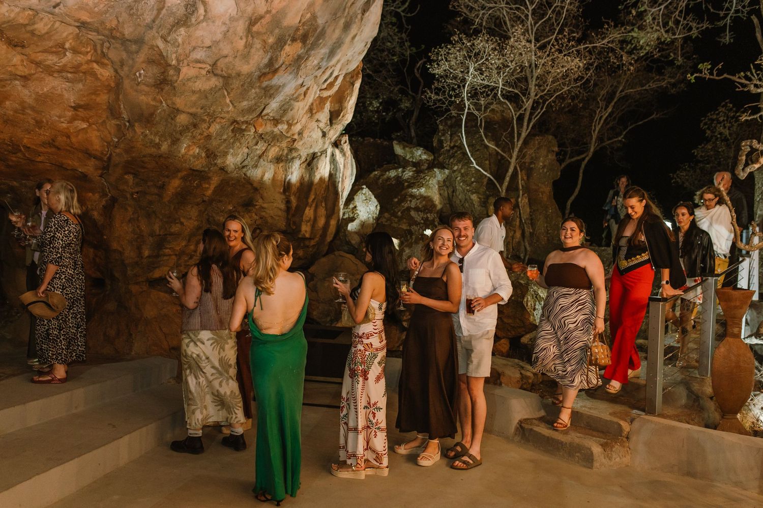 A group of guests gathered in a cave venue for an event.