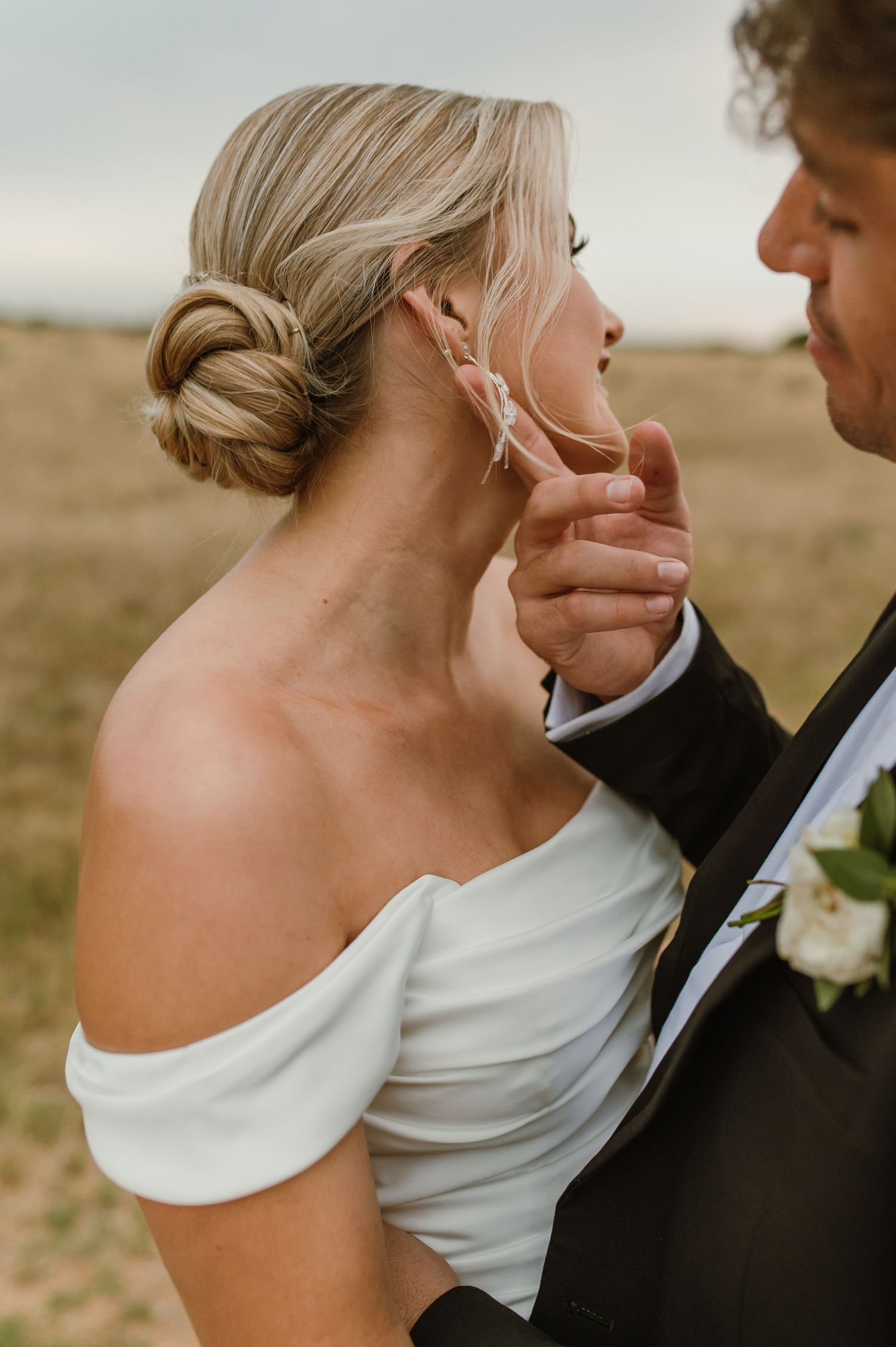 Elegant wedding portraits showing intimate moments between bride in off-shoulder dress and groom.