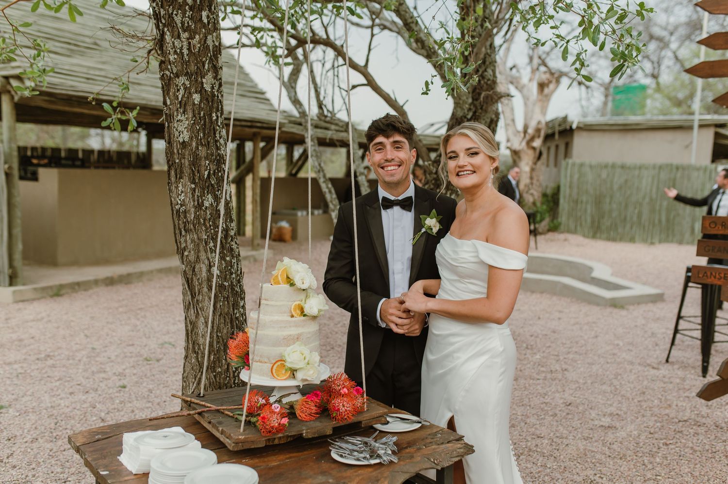 Outdoor wedding reception with guests enjoying refreshments.