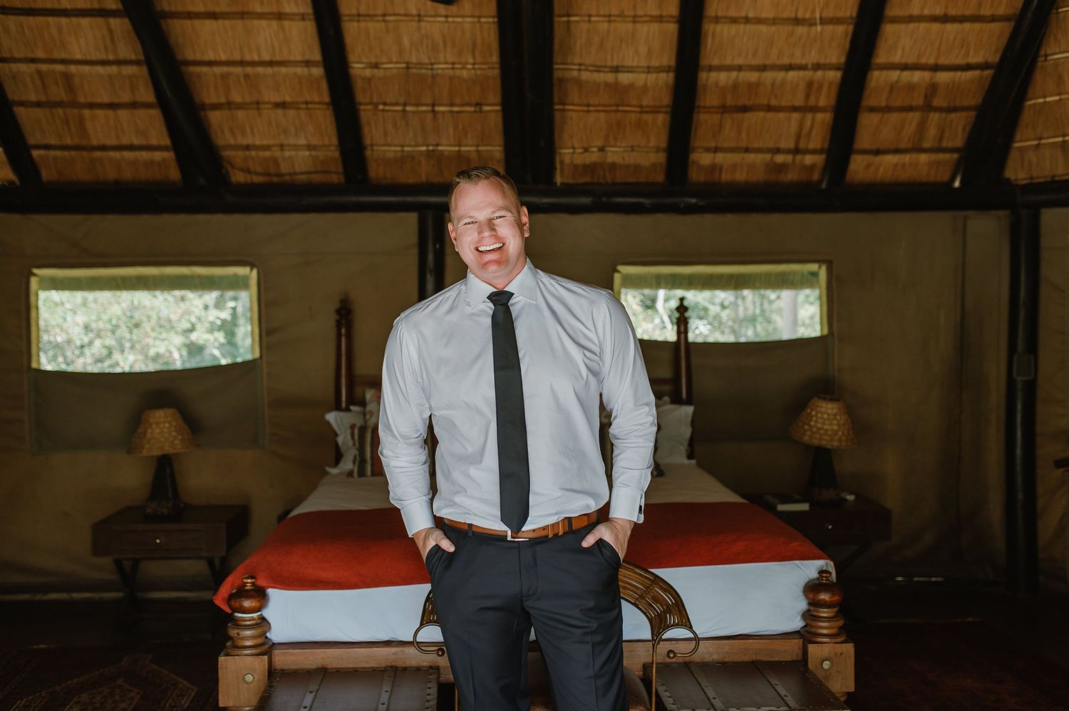 Person in business attire photographed in different poses inside a room with traditional thatched ceiling.