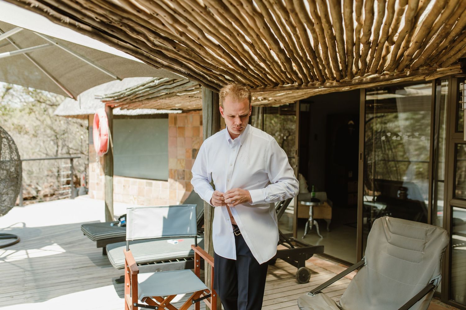 Interior view of a rustic venue with bamboo ceiling and natural lighting.