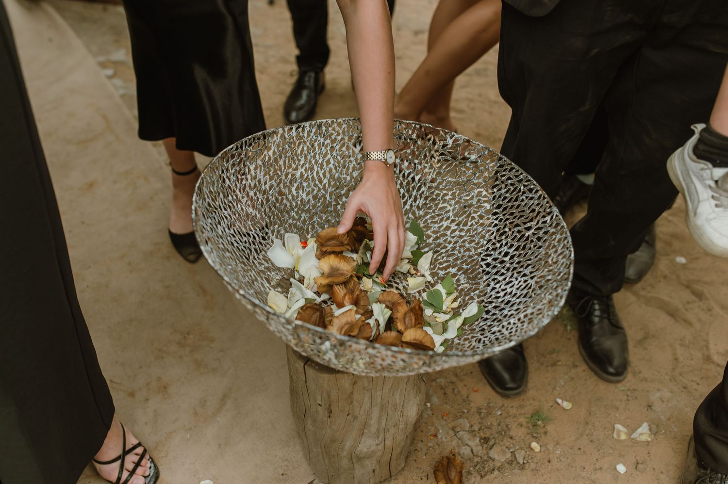 Decorative silver platter holds appetizers at an elegant outdoor reception.