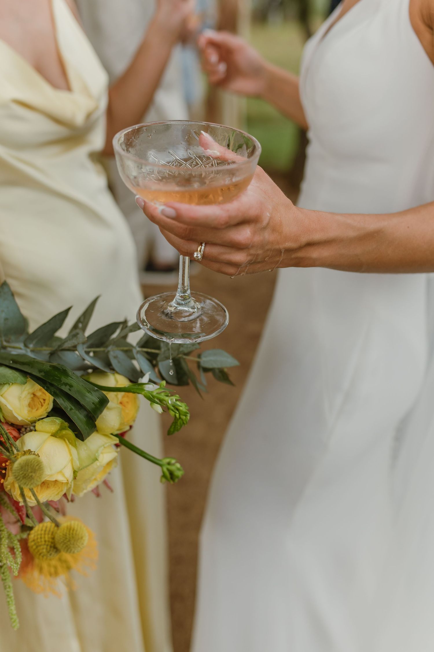 Elegant champagne glasses and yellow floral bouquets create a romantic wedding atmosphere.