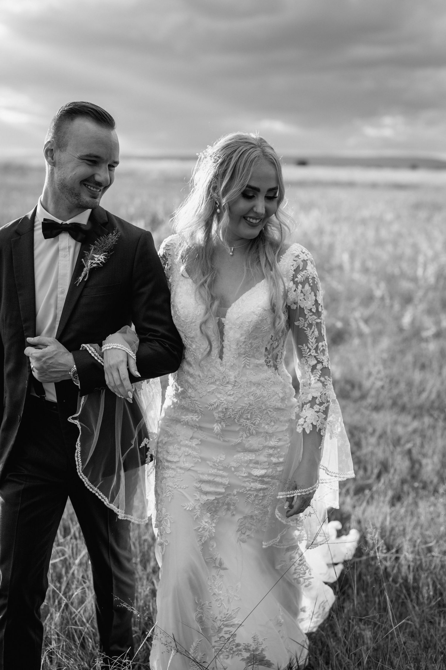 Black and white photo of joyful moments shared in a rustic field setting.